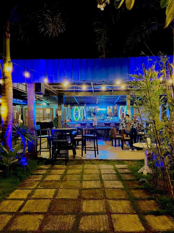 a group of people sitting at a restaurant at night at The Beach House and Bar in Roxas City