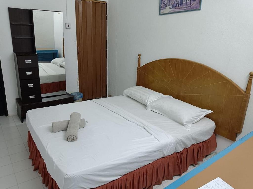 a bedroom with a bed with a teddy bear on it at VKB Ferringhi Styles Penang formerly Grand Star Hotel in Batu Ferringhi