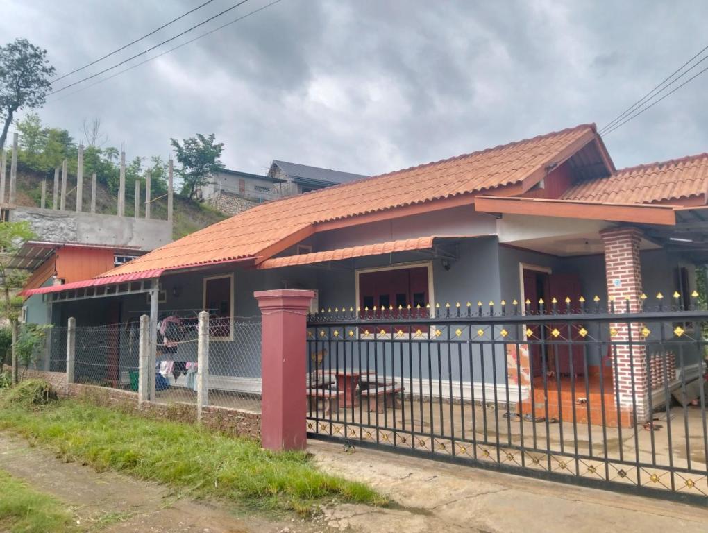 a house with an iron fence in front of it at Ban Thong hostel in Luang Prabang