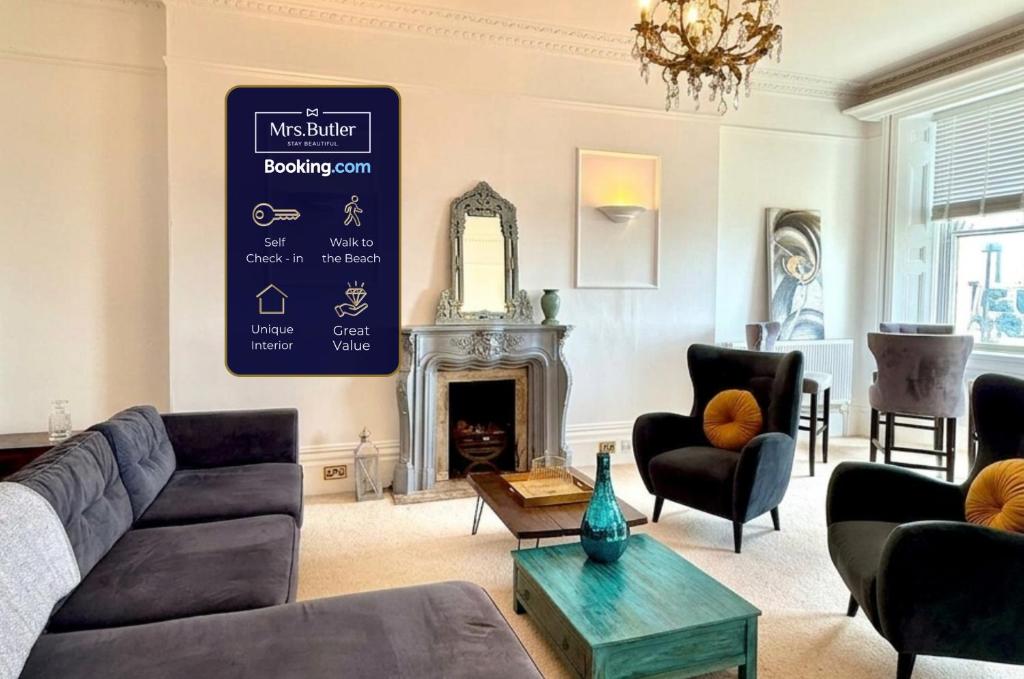 a living room with a couch and a fireplace at Seafront Flat By Mrs Butler Short Term Rental Brighton in Brighton & Hove