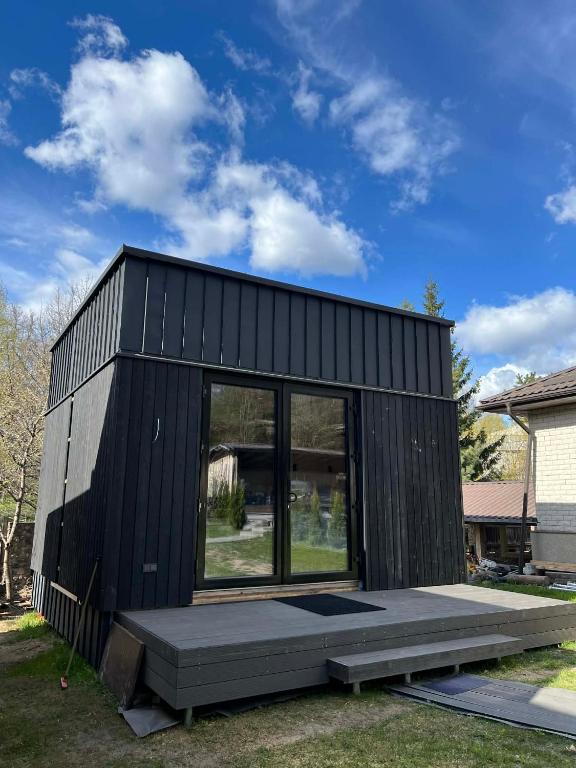 a black tiny house with a large window at Premium homes in VNO