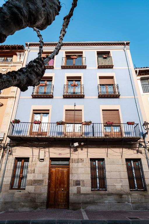 a tall white building with balconies on it at Piso en Casa de Correos in Molina de Aragón