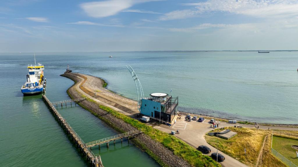 a boat is docked at a dock in the water at Punt al Mare in Vlissingen