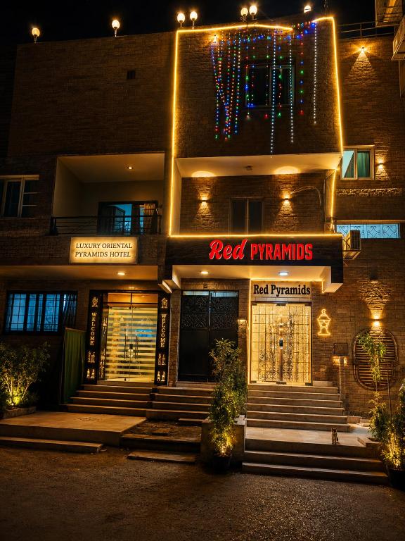 a red xmas sign on the front of a building at Red pyramids view hotels in Cairo
