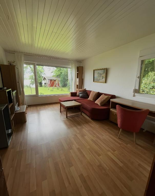 a living room with a couch and a table at Sommerhaus Seeblick in Klausdorf Brandenburg
