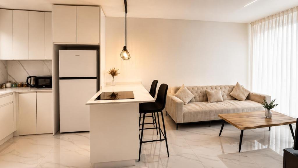 a kitchen and living room with a couch and a table at ODAR suite in Caesarea