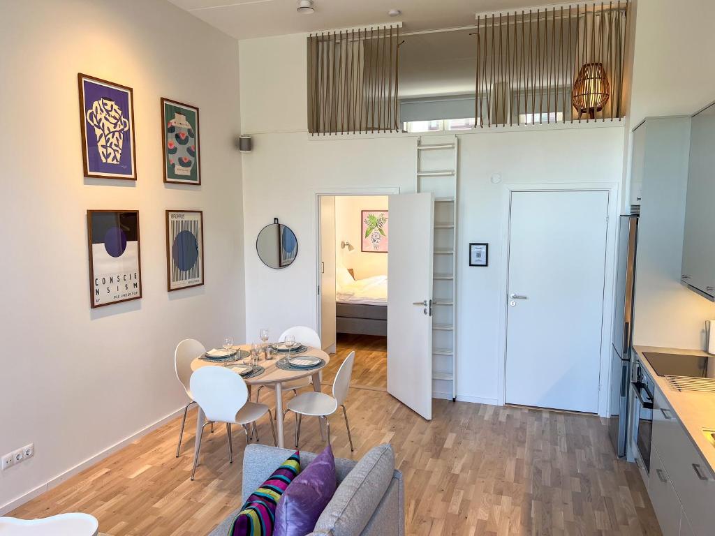 a living room with a table and chairs at Lomma Harbour Apartment in Lomma