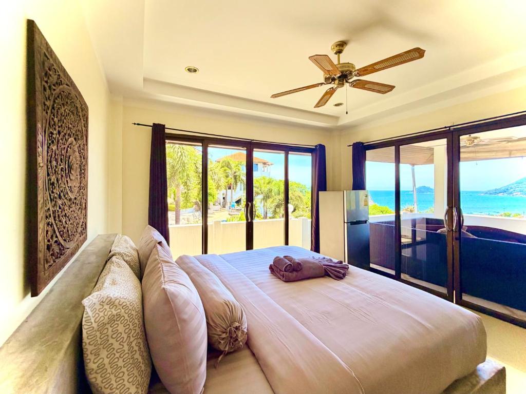 a bedroom with a bed with a view of the ocean at Viking House Villa Deluxe in Ko Tao
