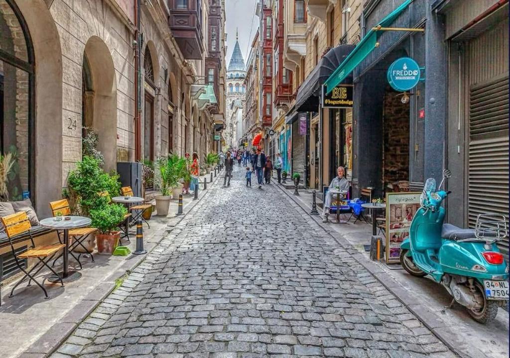 a cobblestone street with people walking down it at The Wilson Galata Hotel in Istanbul