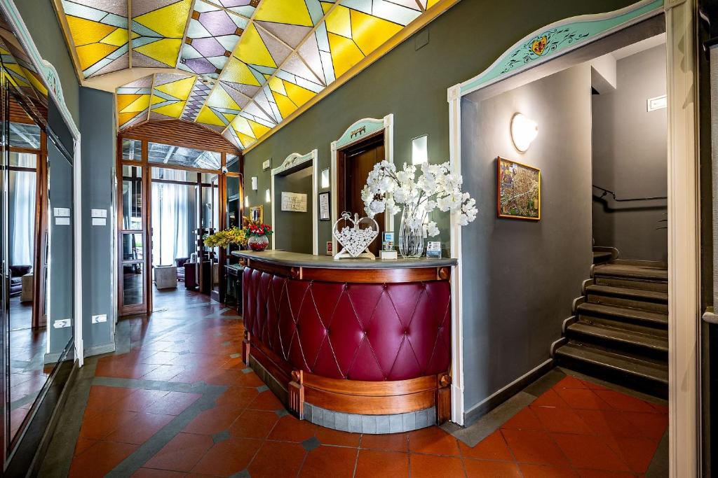 a lobby with a stained glass ceiling and stairs at Grand Hotel Panama Firenze in Florence
