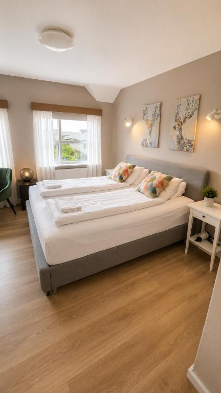 a bedroom with a large bed in a room at Grindavik Guesthouse self check in & out in Grindavík
