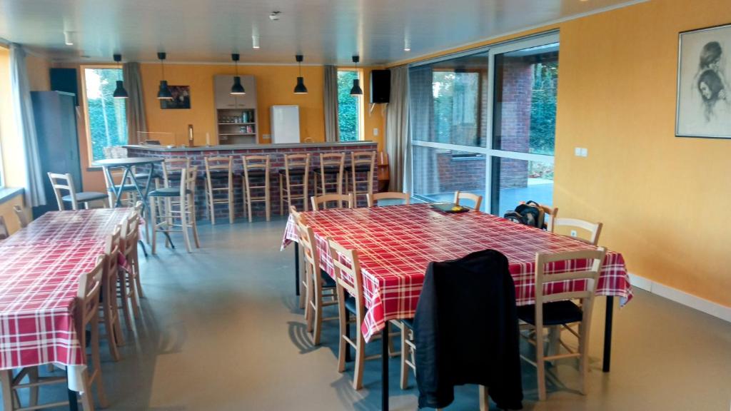 a restaurant with two tables and chairs and a bar at Sophia-Elvira in Diksmuide