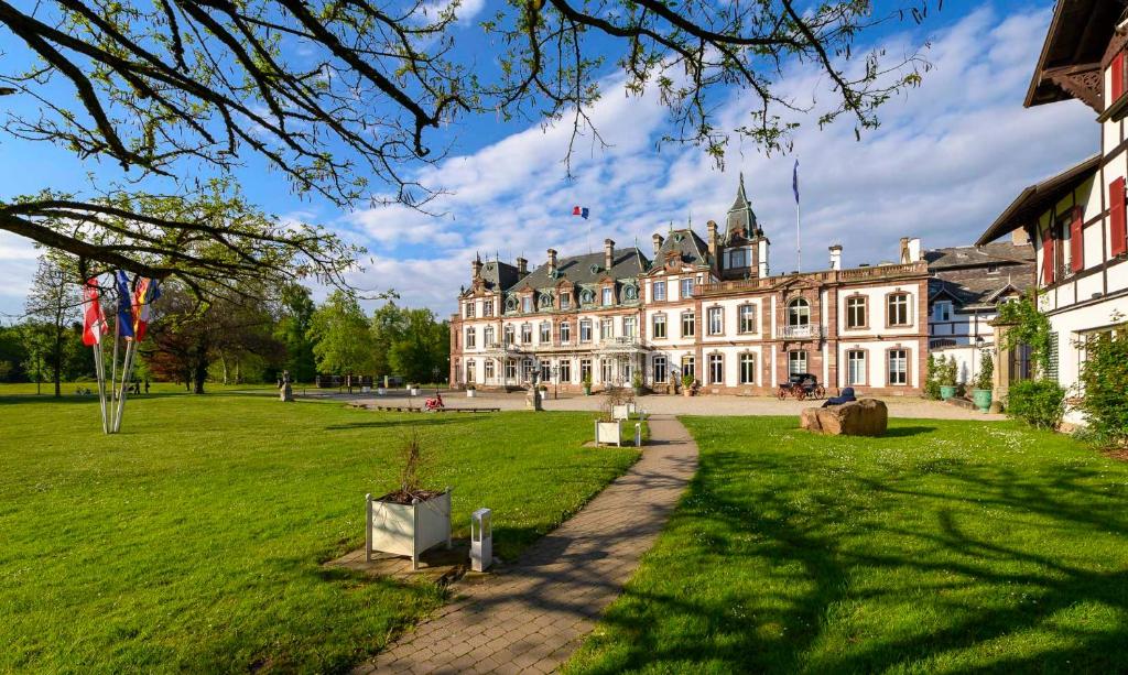 a large building with a green lawn in front of it at Château de Pourtalès in Strasbourg