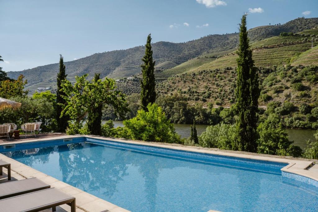 a swimming pool with a view of a mountain at Quinta De São José in Ervedosa do Douro