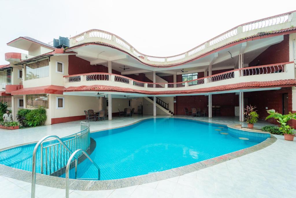 a large swimming pool in front of a building at Treebo Sunshine Beach Resort with Swimming Pool in Calangute