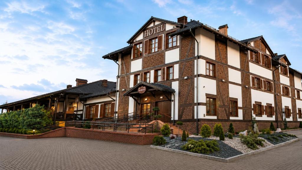a large brick building with aventh floor at Hotel Skarbek in Lubin