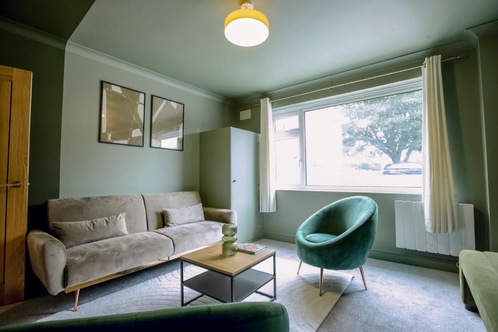 a living room with a couch and a chair at The Whitehouse - Flat B in Carbis Bay
