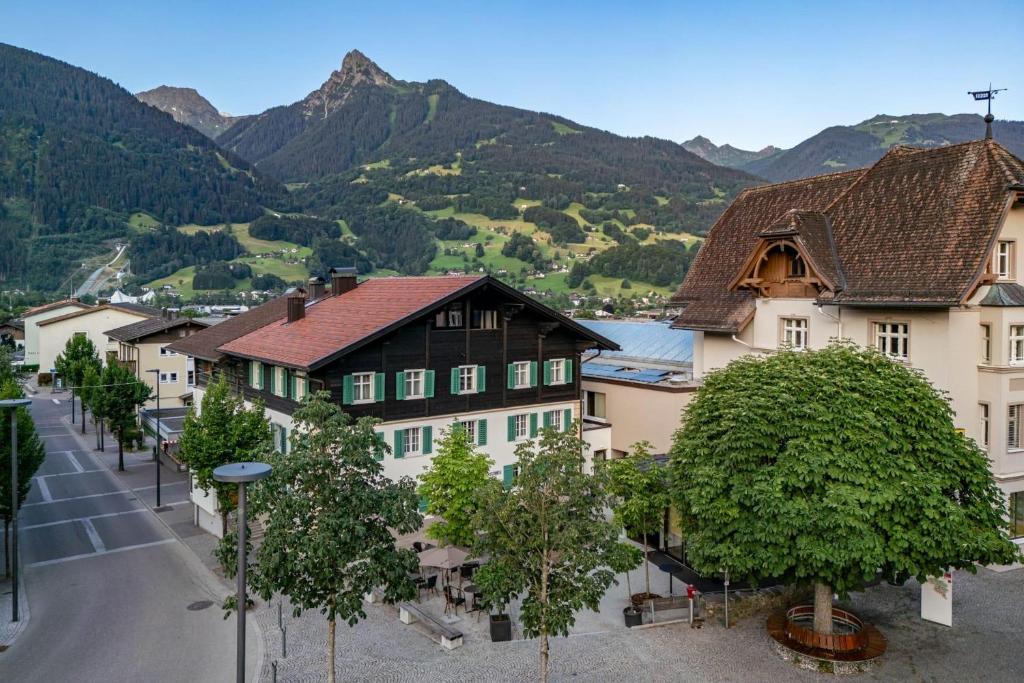 a town with houses and trees and a mountain at Münsterhus Josefs Alpine Lodge in Schruns