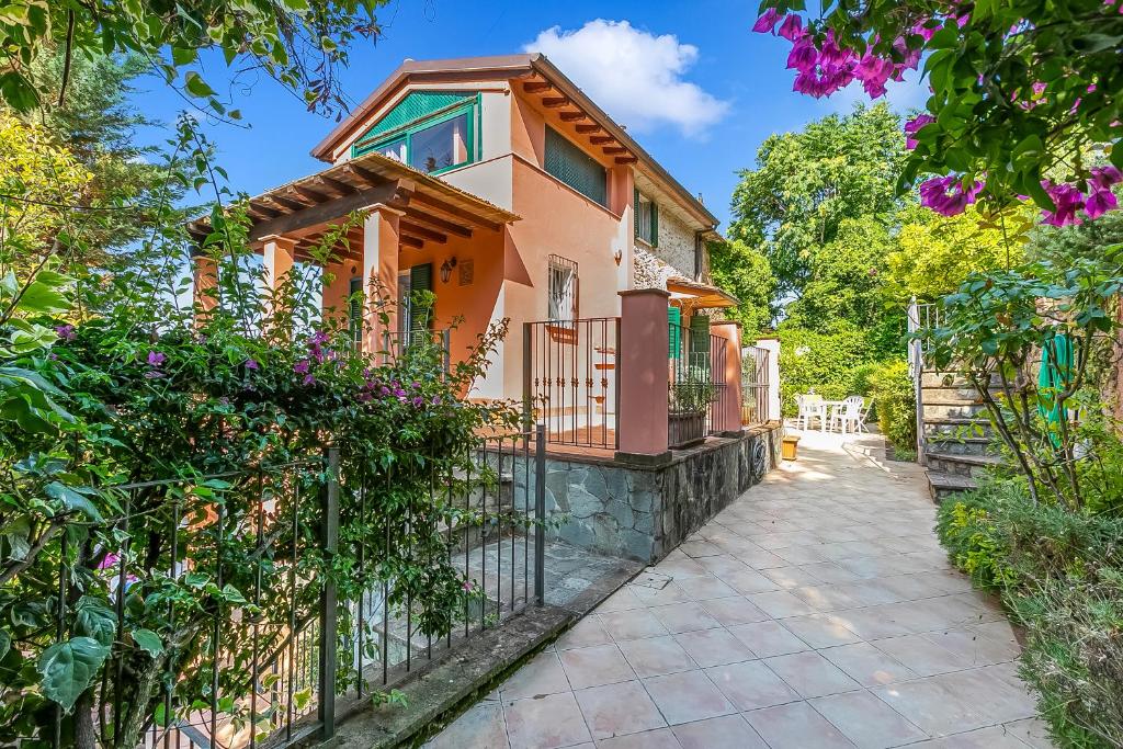 a house with a fence in front of it at Villa Aurora with Sea View in Seravezza