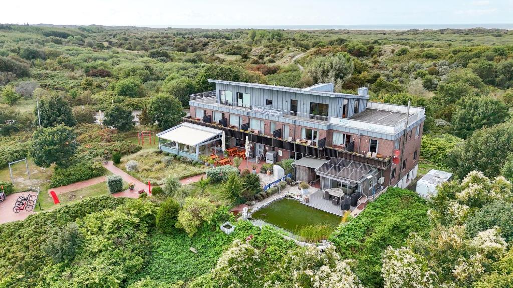 an aerial view of a large house on a hill at Strandwetter Dünenhotel in Borkum
