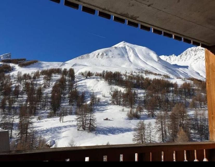a view of a snow covered mountain from a window at T2 view, skiing, summer pool Balcons du Soleil in Allos