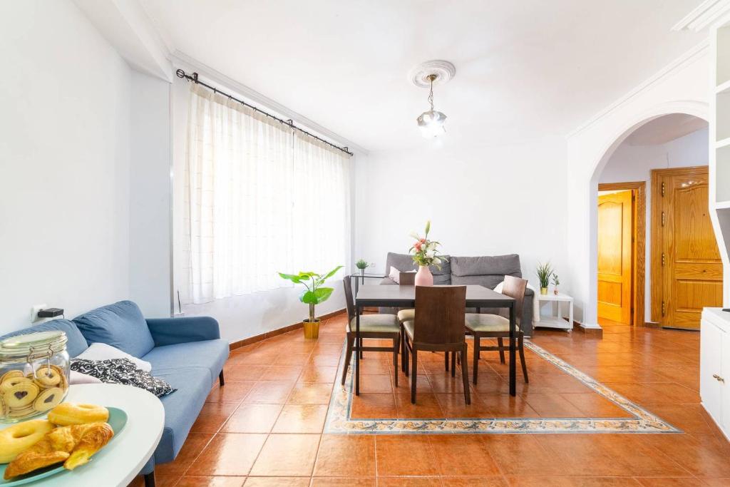 a living room with a blue couch and a table at Casa Maruchi Apartamento 2 in Almería
