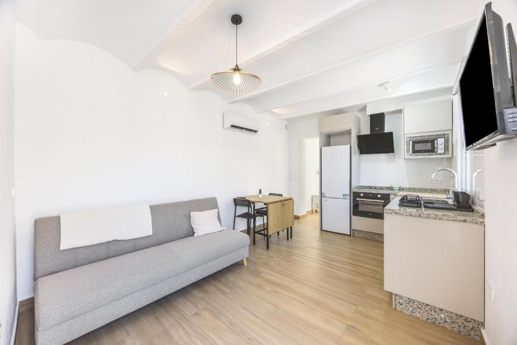 a living room with a couch and a kitchen at Casa Socra in Arcos de la Frontera
