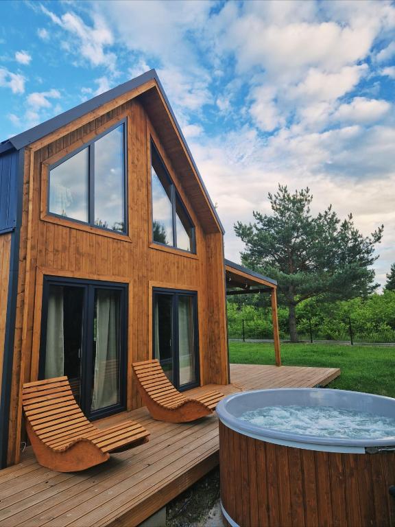 a house with a hot tub on a deck at Sarenka na Roztoczu in Nielisz