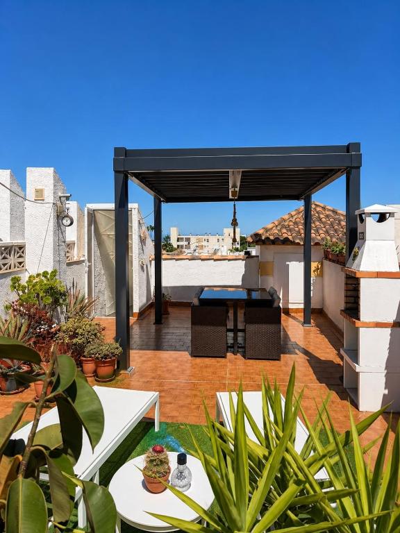 a pergola on the roof of a house with plants at Monte de Santa Pola in Gran Alacant