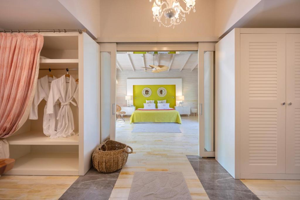 a bedroom with a bed and a dressing room at Villa Lukka in Cıralı