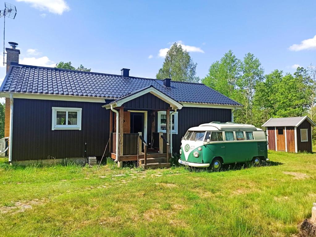 a green van parked in front of a house at Solkullen i Kalvshult in Hallaryd