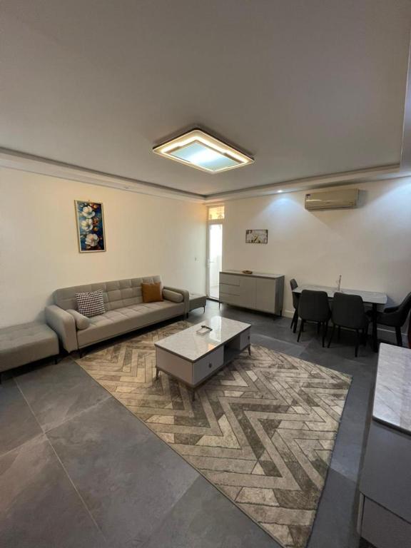 a living room with a couch and a table at Résidence You Royal in Dakar