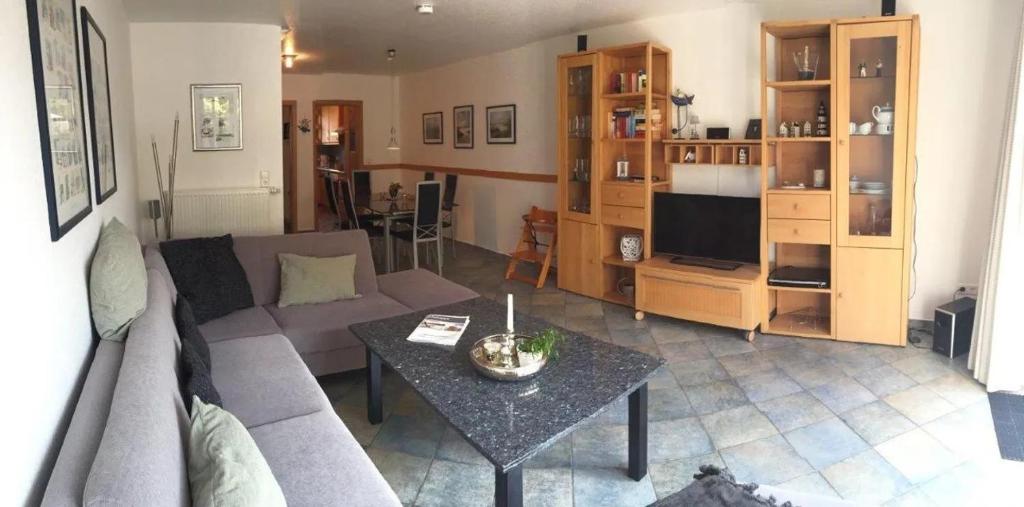 a living room with a couch and a table at Residenz Seelust in Langeoog