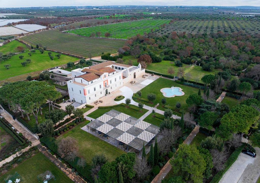an aerial view of a large house with solar panels on it at Relais Il Santissimo in Turi
