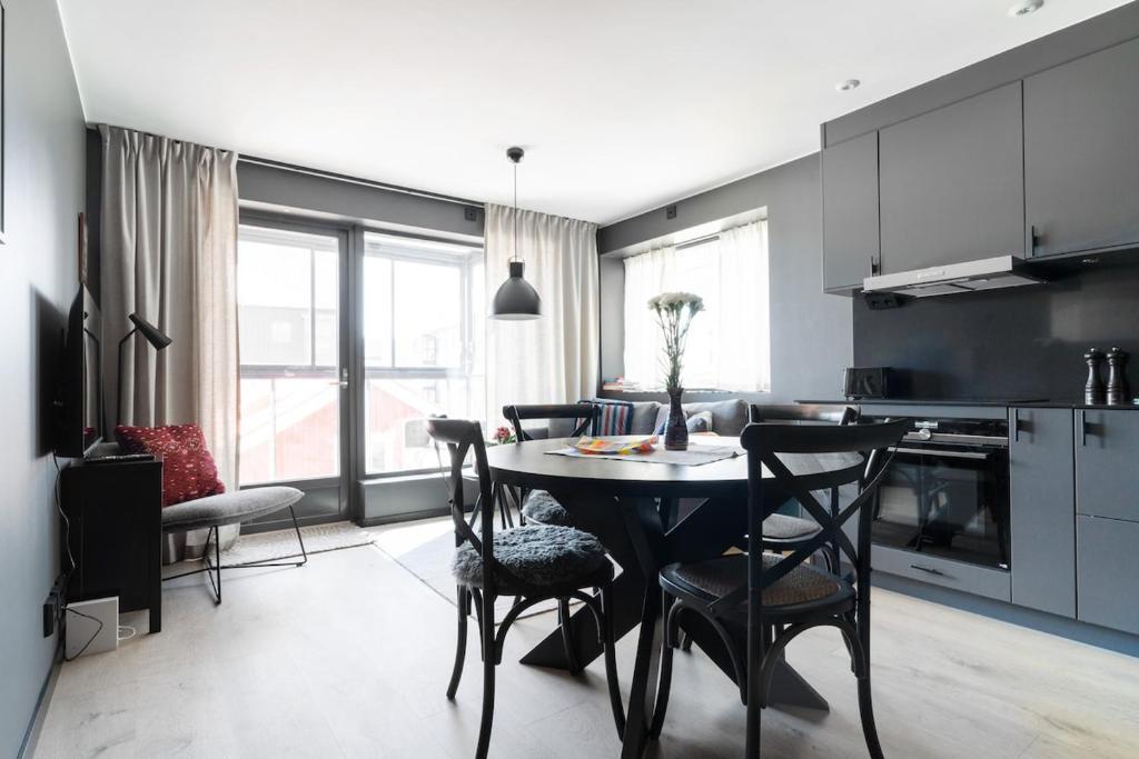 a kitchen and dining room with a table and chairs at View Studios in Åre