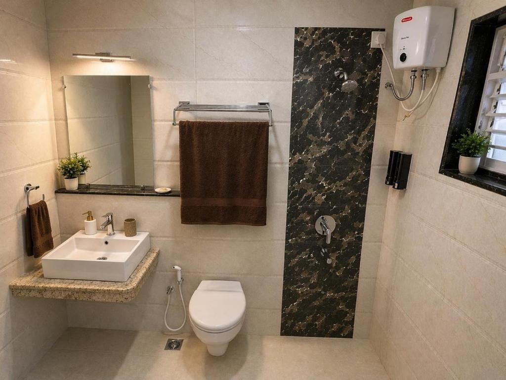 a bathroom with a toilet and a sink at Rovio in Vagator