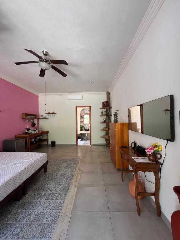 a bedroom with a bed and a ceiling fan at Casa Sayab Hotel Boutique in Maní