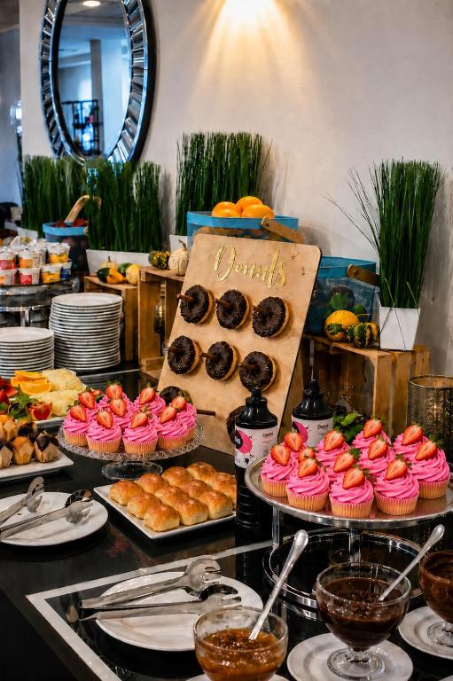 a buffet of pastries and donuts on a table at Prawdzic Family Resort & Wellness in Gdańsk