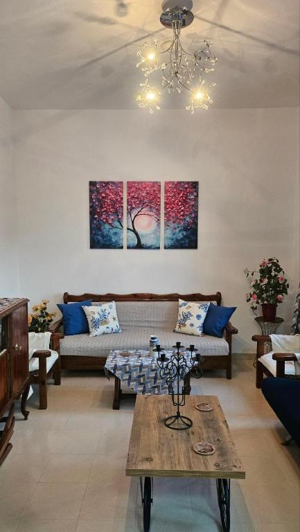 a living room with a couch and a table at Sea Breeze Retreat in Lionas