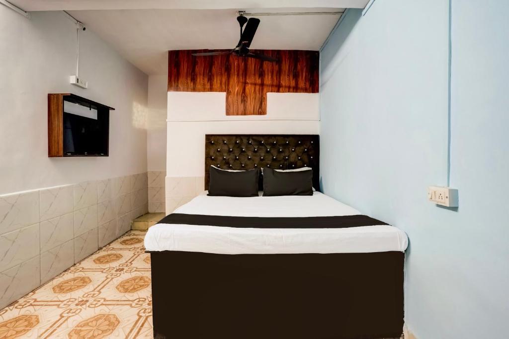 a bedroom with a large bed in a room at Hotel O Vira Palace in Mumbai