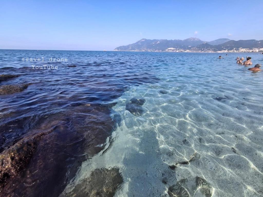 a group of people in the water at a beach at Chalet Nautilus in San Mango Piemonte