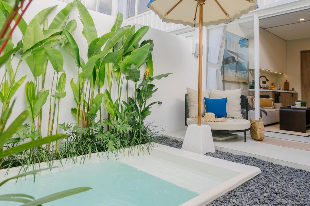 a living room with plants and a pool at Villa Drift, Balangan 1BR Surf Getaway in Bingin Beach