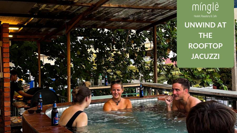 a group of people in a hot tub at a restaurant at Chinatown Hostel by Mingle - Rooftop Private Jacuzzi with Bar in Kuala Lumpur
