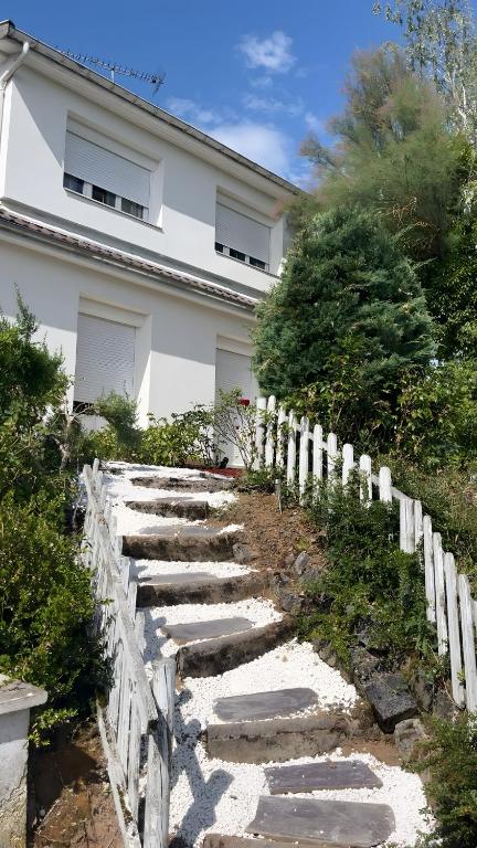 a stone path in front of a white house at Gîte Aux Anges 51 in Thiéblemont-Farémont