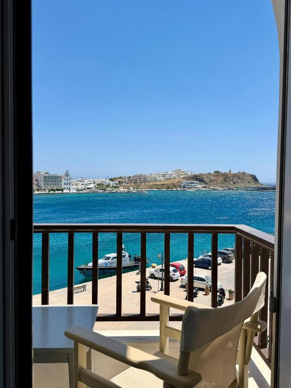 a balcony with a view of the water and boats at Hotel Lito in Tinos