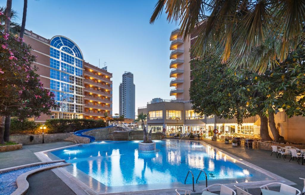 a large swimming pool in a city with buildings at Hotel Alone in Cala de Finestrat