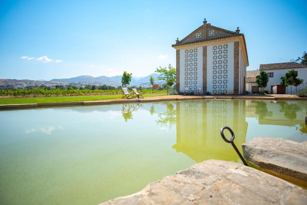 a large pool of water in front of a building at Cortijo de la Seda in Granada
