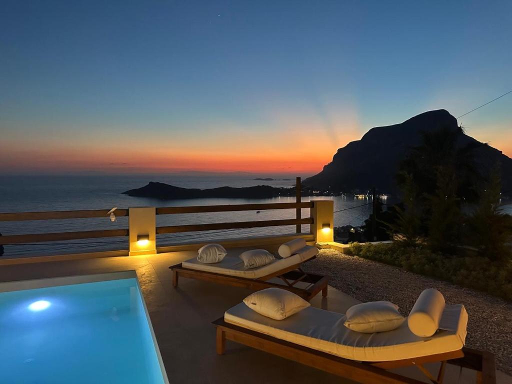 a villa with two beds and a swimming pool at sunset at Villa Ino in Myrties