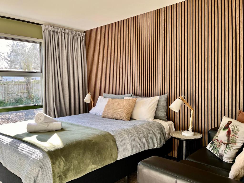 a bedroom with a large bed and a window at Mt Dobson Motel in Kimbell