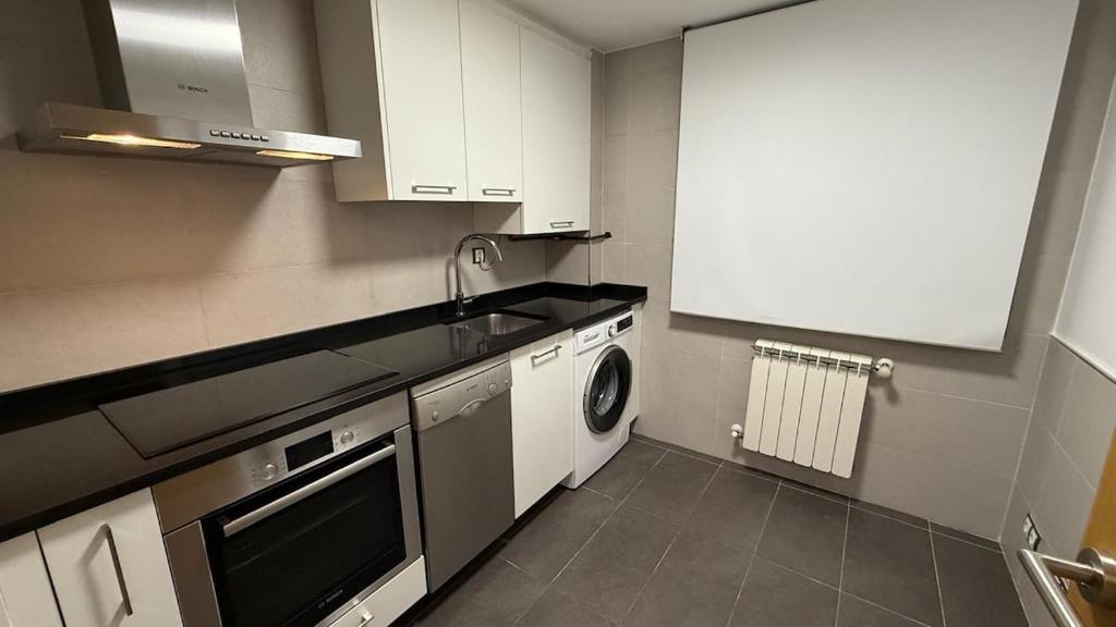 a kitchen with a sink and a dishwasher at Playa America 1E by YBH in Nigrán